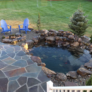 Patio and pond setup in the backyard - Pondscapes Maryland