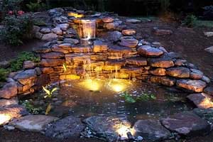 Beautiful pond with waterfall and lights