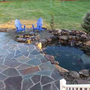 Above ground pond with rocks and grasses Pondscapes Maryland