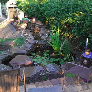 Patio by a backyard pond - Pondscapes Maryland