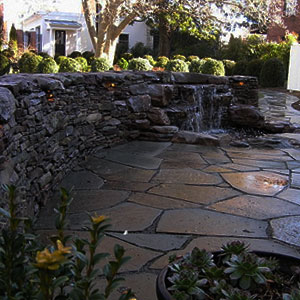 Rock wall with waterfall and patio -  Pondscapes Maryland