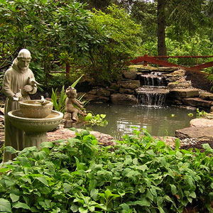 Pond with waterfall, fecning and statues -  Pondscapes Maryland